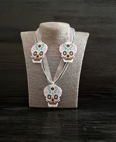 Let me me present you festival style gothic beadwork jewelry set. This sugar skull seed bead earrings and pendant necklace would be great happy Halloween gift set jewelry. The length of the cord is 18.1 (+2) inches. The cord consists of 2 waxed cords of black color, one cord white color and a white ribbon. Pendant high is 2.2 inches, pendant width is 1.8 inches. The length of earrings is 3 inches, the width is 1.8 inches, the length without closure (drop length) is 2.2 inches. You can buy earrings from this set separately by this link https://www.etsy.com/listing/720553398/sugar-skull-helloween-earrings-fesival?ref=shop_home_active_8&frs=1 You can buy pendant necklace from this set separately by this link https://www.etsy.com/listing/721523768/human-sugar-skull-beadwork-art-pendant?ref=sho Day Of The Dead Beaded Jewelry Gift, Handmade Bohemian Jewelry For Halloween, Handmade Beaded Necklaces For Halloween Gift, Festival Skull-shaped Beaded Jewelry, White Skull Jewelry For Day Of The Dead, Handmade Black Jewelry For Day Of The Dead, Beaded Jewelry For Halloween Festival, Black Jewelry For Day Of The Dead Gift, Day Of The Dead Skull Jewelry Gift