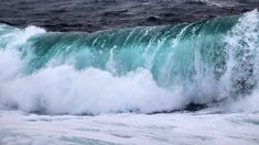 an ocean wave is crashing into the shore