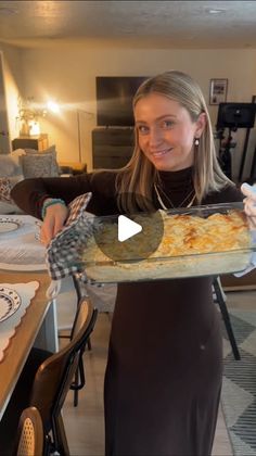 a woman holding a tray with food on it