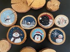 wooden slices with snowmen painted on them and some wood slices cut into smaller pieces