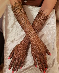 a woman's hands with hennap on it, showing the intricate design