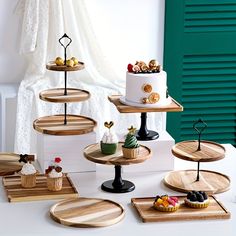 a table topped with lots of wooden trays filled with cakes