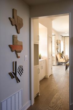 there is a dining room and living room in this house with wood pieces on the wall