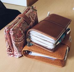 several wallets stacked on top of each other with one opened and the other closed