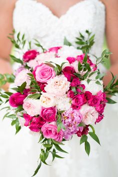 a bridal holding a bouquet of pink and white flowers