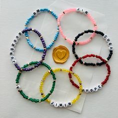 six bracelets with the word hope written on them and a gold medal in the middle