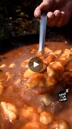 a person is stirring some food in a pot