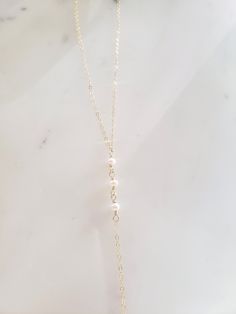 "These dainty and thoughtfully designed necklaces are stunning paired as a set or on their own! Would be wonderful for a bride or as a feminine and lovely touch to your every day. Genuine freshwater pearls are wire wrapped in a minimal/vintage-y/boho style. Made from top quality materials- true 14k gold fill or solid sterling silver, will not tarnish or turn you green, wear 24/7! Secured with an easy to use oval lobster clasp. Lead and nickel free. Excellent for sensitive skin! Come packaged in Delicate 14k Gold Filled Lariat Jewelry, Elegant Pearl Layered Necklace With Delicate Chain, Elegant White Layered Necklace With Adjustable Chain, Elegant Layered Necklace With Pearl Charm For Gift, Elegant Gold Layered Necklace With Pearl Charm, Long Pearl Charm Necklace For Weddings, Pearl Charm Long Necklace For Wedding, Delicate Pearl Lariat Necklace With Pendant, Pearl Chain Necklace With Pearl Charm For Wedding