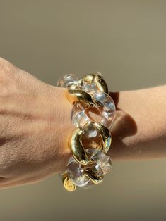 18k gold and crystal large link bracelet by Seaman Schepps. DESIGNER: Seaman Schepps MATERIAL: 18k Gold GEMSTONES: Crystal DIMENSIONS: Bracelet is 8 1/8" long end to end, approx. wearable length is 7-7.5", width 30mm. MARKED/TESTED: 1959, Seaman Schepps, Shell mark, 750. WEIGHT: 113.1 grams. CONDITION: Previously Owned, Excellent Condition. Luxury Solid Link Jewelry For Parties, Modern Chunky Chain Bracelets For Party, Luxury Chain Link Party Bracelets, Luxury Chain Link Bracelets For Parties, Modern Lucite Bangle Jewelry, Clear Bangle For Formal Occasions, Clear Bangle Jewelry For Formal Occasions, Round Lucite Jewelry For Parties, Clear Bracelet Jewelry For Party