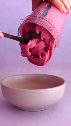 pink punch smoothie bowl being poured into a white bowl with the words pink punch smoothie bowl above it