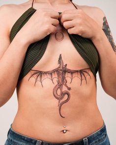 a woman with a dragon tattoo on her stomach