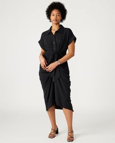 The TORI dress has a rolled collar and cuffed short sleeves, with an adjustable gathered tie-front waist and a high-low hem. The dress is finished with a lightweight woven crepe fabric, giving it a polished look. Tie-front midi shirt dress Button-up closure Elastic in back Length: 48" 100% polyester Hand wash Trea is 5ft 10in and is wearing a size 12 Maelyn is 5ft 11.5in and is wearing a size 4 Imported Chic Short Sleeve Viscose Shirt Dress, Short Sleeve Shirt Dress With Tie Waist For Daywear, Short Sleeve Rayon Midi Dress For Work, Short Sleeve Shirt Dress With Tie Fastening For Work, Short Sleeve Midi Dress With Gathered Waist For Work, Workwear Midi Dress With Gathered Waist And Short Sleeves, Rayon Short Sleeve Dress For Work, Short Sleeve Rayon Dress For Work, Fitted Rayon Shirt Dress With Short Sleeves