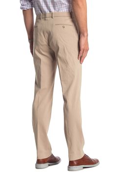 Fit: this style fits true to size. Zip fly with hook-and-bar and button closure. Front slash pockets; back besom pockets. Solid tan. Light stretch. Approx. 10.5" rise (size 34x32). Imported 4-way Stretch Dress Pants For Business Casual In Spring, Spring 4-way Stretch Dress Pants For Business Casual, Fitted Chino Cotton Twill Bottoms For Business Casual, Slim Fit Wide Leg Chinos For Business Casual, Business Casual Slim Fit Wide Leg Chinos, Tommy Hilfiger Straight Leg Pants With Welt Pockets, Solid Flat Front Chinos For Business Casual, Tommy Hilfiger Tapered Leg Pants With Pockets, Solid Color Flat Front Chinos For Business Casual