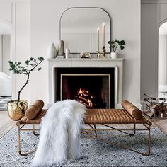 a living room filled with furniture and a fire place in the middle of the room