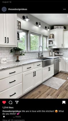 a clean kitchen with white cabinets and wood flooring is seen in this image from the front view