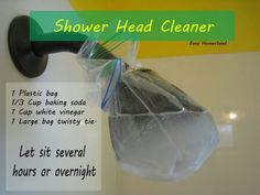 there is a plastic bag hanging on the wall next to a sign that says shower head cleaner