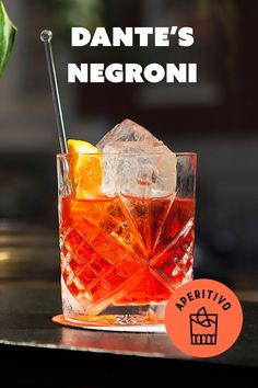 an orange and red drink in a glass with the words, dante's negroni