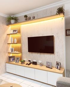 a living room with a large flat screen tv mounted to the side of a wall