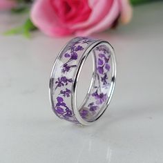 Resin ring meticulously crafted using real flowers and fully cured UV resin. The flowers silver ring is inspired by the graceful charm of Boho jewelry. This purple ring gift is a perfect meaningful gift for a beloved woman, and as a pampering gift for yourself. The jewelry is very flattering, lightweight, comfortable to wear as jewelry for everyday use and impressive as jewelry for a special occasion. Each piece is individually crafted to order, ensuring a unique touch, with subtle variations that make every piece truly one-of-a-kind. Elevate your style with this exceptional jewelry- a wearable piece of art designed for your enjoyment. Purchase now for an exquisite blend of nature and craftsmanship. Special Features: - Handmade with Sterling silver, real flowers, fully cured UV resin  - Fl Flower Shaped Rings With Pressed Flowers As Gifts, Flower Shaped Rings With Pressed Flowers, Nature-inspired Pressed Flower Ring Jewelry, Flower Shaped Pressed Flowers Rings, Nature-inspired White Gold Flower Ring, Sterling Silver Rings With Natural Inclusions For Gift, Adjustable Pressed Flowers Ring For Wedding, Silver Wedding Jewelry With Pressed Flowers, Wedding Jewelry With Pressed Flowers In Silver