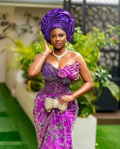 a woman in a purple dress and head scarf