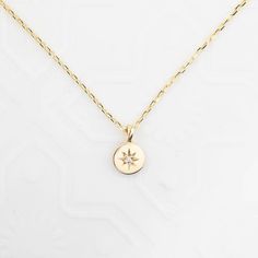 "This necklace symbolizes Sirius, the brightest diamond in the night sky and it is a perfect choice for layering with our star constellation necklace. This handcrafted necklace is lightweight yet very sturdy. The chain is faceted and shimmers as you wear it. Disc size: approx. 5.8mmx5.8mm White diamond, approx. 0.006ct G color SI clarity Solid 14k gold diamond cut chain, adjustable lengths at 16\" and 18\" with spring ring clasp Made of 100% solid gold and ethically sourced gemstone" Delicate 14k Gold Jewelry With Star Charm, 14k Gold Celestial Necklace With Single Cut Diamonds, 14k Gold Dainty Jewelry With Star Charm, Minimalist 14k Gold Star Of David Necklace, Dainty 14k Gold Star Charm Jewelry, Minimalist Yellow Gold Jewelry With Star Charm, Delicate Yellow Gold Star Jewelry, Celestial Sterling Silver Necklace With Single Cut Diamonds, Yellow Gold Star Of David Jewelry With Delicate Chain