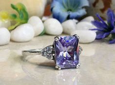 Don't miss this opportunity to own this beautiful gemstone ring crafted in 14k gold filled => Gemstone Type - Lab Grown Amethyst, Clear Quartz => Gemstone Cut - Faceted => Gemstone Size - 8*10 mm, 2 mm => Total Number of Gemstones - 7 => Metal Type - 14k Gold Filled (Tarnish Resistant And Nickel Free) - also available in 925 sterling silver * Please contact me for pricing on a sizes larger than 11 * ~ Feel free to ask me about custom made designs. ❏ Replacements and custom orders Rectangular Amethyst Ring With Accent Stones, Purple Rectangular Ring Gift, Rectangular Amethyst Ring For Anniversary, Rectangular Amethyst Wedding Rings, Rectangular Purple Rings With Accent Stones, Purple Rectangular Gemstone Ring, Ring Rectangle, Gold Ring Engagement, Rectangle Ring