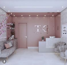 the interior of a nail salon with pink walls and white flooring, two gray couches