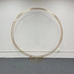 a circular metal object sitting on top of a carpeted floor next to a white wall