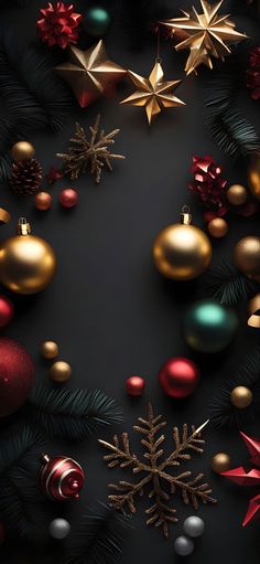 an overhead view of christmas decorations on a black background with gold and red baubles