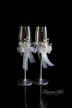 two wine glasses with bows and pearls on them