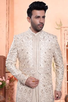 Get ready to say "I do" in style in our Mens Sherwani! This groom sherwani features stunning thread embroidery with zardozi, sequin, and stone detailing for a truly luxurious look. Perfect for your special day, this sherwani will have you feeling like a king (or at least a prince) as you walk down the aisle. Luxury White Sherwani With Pearl Embroidery, White Embroidered Bollywood Sherwani, Off-white Sherwani With Intricate Embroidery, Fitted Embroidered Off-white Sherwani, Fitted Off-white Embroidered Sherwani, Groom Sherwani, Mens Sherwani, Walk Down The Aisle, A Prince