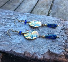 ✦Beautiful handmade and original designed Czech glass navy blue/antique bronze plated/raw brass Boho Chic earrings with Zinc based alloy enamel painted disc charm in gold plated multi color abstract design. ✦Spiritual Jewelry designed and carefully handmade by Rushweaver Jewellery in an ancient earthy tribal style. ✦These boho flower earrings dangle 75mm from the top of nickel free, solid brass, antique plated ear wires. ✦For all free spirited women who want to enjoy their unique style! Blue Beaded Brass Earrings With Ear Wire, Blue Brass Beaded Earrings With Ear Wire, Gift Blue Beaded Brass Earrings, Blue Beaded Brass Earrings As Gift, Blue Beaded Dangle Earrings In Brass, Blue Dangle Beaded Brass Earrings, Blue Beaded Brass Dangle Earrings, Blue Brass Beaded Dangle Earrings, Handmade Bronze Czech Glass Earrings