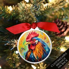 a colorful rooster ornament hanging on a christmas tree