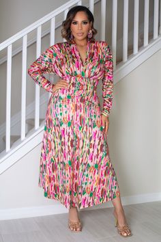 The Malia dress features a deep V-neck and a shawl collar, with a regular fit and high waistline. Its multicolor all-over print and long sleeves give it a touch of sophistication, while the slight stretch fabric offers comfort and a flattering silhouette. Perfect for both casual and elegant occasions, this A-line dress exudes an air of luxury and taste. 95% Polyester, 5% Elastane Model is wearing size small Please allow 3-5 business days to process and ship. Product Measurements in cm : Size US Bust Waist Size Length Sleeve Length Cuff S 4 96 62-96 132 68.5 20 M 6 100 66-100 134 69.7 21 L 8/10 106 72-106 136 70.9 22.5 XL 12 112 78-112 138 72.1 24 XXL 14 118 84-118 140 73.3 25.5 Multicolor Printed V-neck Dress, V-neck Multicolor Print Maxi Dress, Multicolor V-neck Maxi Dress With Vibrant Print, Multicolor Vibrant Print V-neck Dress, Multicolor Bold Print V-neck Dress, Deep V Neck Dress, Womens Cami, Shawl Collar, Deep V Neck