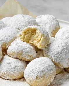 powdered sugar covered doughnuts on a plate