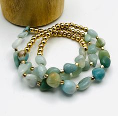 Our 'Cameron Bracelet Set' has a combination of natural shaped amazonite beads in different variations and textures contrasted with gold colored beads, making this bracelet set a stand out. It would pair well with most any outfit, and would make the sweetest gift, too! Natural shaped beads accented with gold colored beads Bracelet Set includes 3 separate bracelets Stretch Bracelets fit most Gold Amazonite Beaded Bracelets, Gold Beaded Bracelets With Amazonite Round Beads, Gold Beaded Amazonite Bracelets, Gold Amazonite Round Beaded Bracelets, Vintage Soul, Sweet Gifts, Natural Shapes, Stretch Bracelets, Bracelet Set