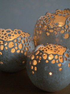 three lit candles sitting next to each other on a table