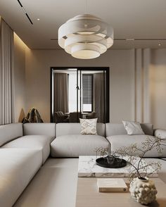 a living room filled with white couches and pillows on top of a wooden table