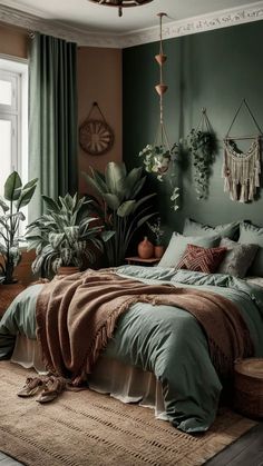 a bedroom with green walls and lots of plants in the corner, including potted plants