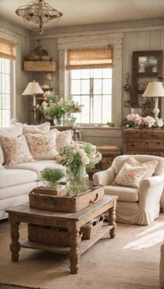 a living room filled with lots of furniture and flowers in vases on the coffee table