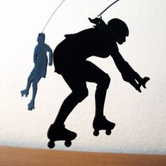 a shadow of a skateboarder and a person on a skateboard in the air