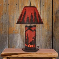 a lamp that is sitting on top of a wooden table in front of a wood paneled wall