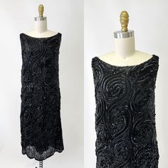 *Fully beaded with alternating glass beads and sequin in a swirl pattern on netting *Elegant portrait neckline *Slips over the head Measurements: Bust: 33" Waist 34" Hip: 38" Shoulder to Hem: 40" Very good condition.  Most likely a tabard that was hand stitched to another original 20s dress, hence the square underarm (beaded part)  From the Dolores O. Luckow estate. Please go by your own measurements, not how it looks on the mannequin, some dresses may be pinned in the back to fit the mannequin. Luxury Black Sleeveless Flapper Dress, Black Knee-length Gatsby Flapper Dress, Black V-neck Flapper Dress For Party, 1920s Black Knee-length Flapper Dress, Vintage Black Flapper Dress With Beaded Fringe, Elegant Portrait, 20s Dress, Portrait Neckline, Beaded Flapper Dress