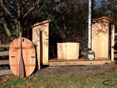 an outdoor area with several wooden outhouses