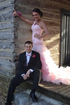 a man in a tuxedo sitting next to a woman in a pink dress