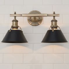 two black lamps are hanging on the wall