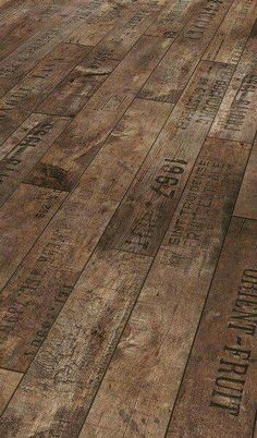 an old wooden floor with many different types of words on it and numbers painted on the wood