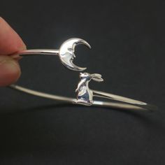 "Rabbit with a Crescent Moon symbolizes Creativity, Dreams, Growth, and Power. It's a great inspirational graduation gift for her who started their career or business.  This bracelet will serve as a motivational tool to help her in her decision-making, succeed in business, and have an American Dreams that she always wanted. It's comfortable to wear and it's everyday friendly, durable and fit for both men and women. Base Material: Sterling Silver  Depth: 23mm (Approximately) Style: Bangle Bangle Handmade Moon Shape Bracelets As Gift, Silver Moon-shaped Bracelet For Gifts, Symbolic Round Cuff Bracelet Gift, Moon And Rabbit, Rabbit Bracelet, Silver Bracelet Designs, American Dreams, The Bangles, Bracelets Design