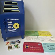 a blue machine sitting on top of a table next to several different types of cards