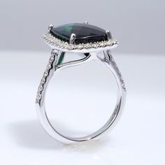 This strikingly beautiful 6.93 carats Green Tourmaline with great clarity has the perfect combination of dark green and light green hues making the gem appear flawless. Set in 14K white gold, this ring will highlight your skin flawlessly. Order online info@jupitergem.com Luxury Green Rings With Polished Finish, Luxury Green Diamond Ring In 14k White Gold, Green Tourmaline Rings With Halo Setting, Green Tourmaline Jewelry With Halo Setting, Green Tourmaline Ring With Halo Setting, Luxury Green Tourmaline Emerald Ring, Fine Jewelry Lime Green Gemstone Ring, Luxury Lime Green Gemstone Ring, Luxury Brilliant Cut Green Gemstones